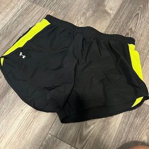 Size medium under armour black running shorts with lime green neon accents